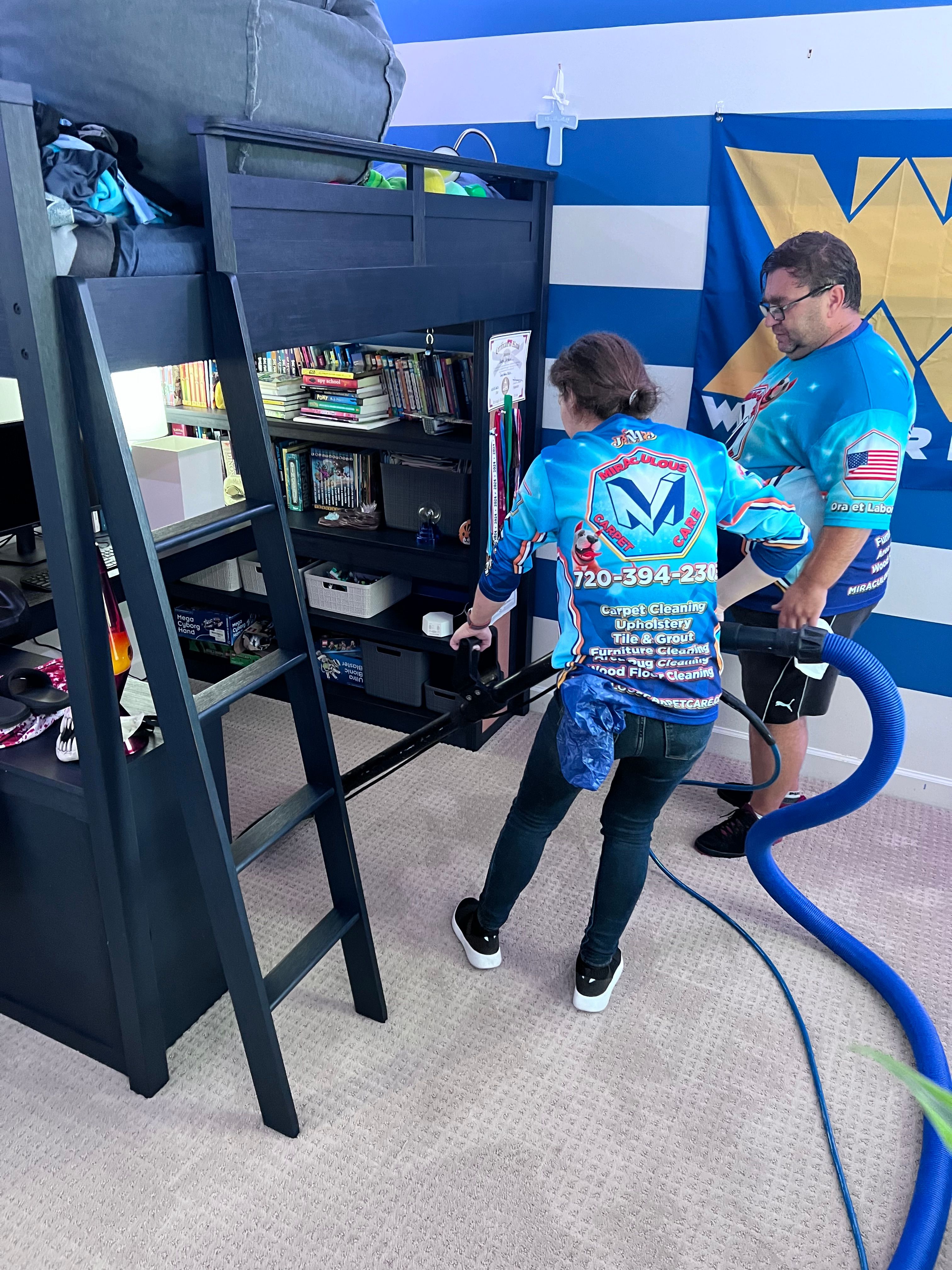 Two Miraculous Carpet Care technicians cleaning carpet in a child's bedroom