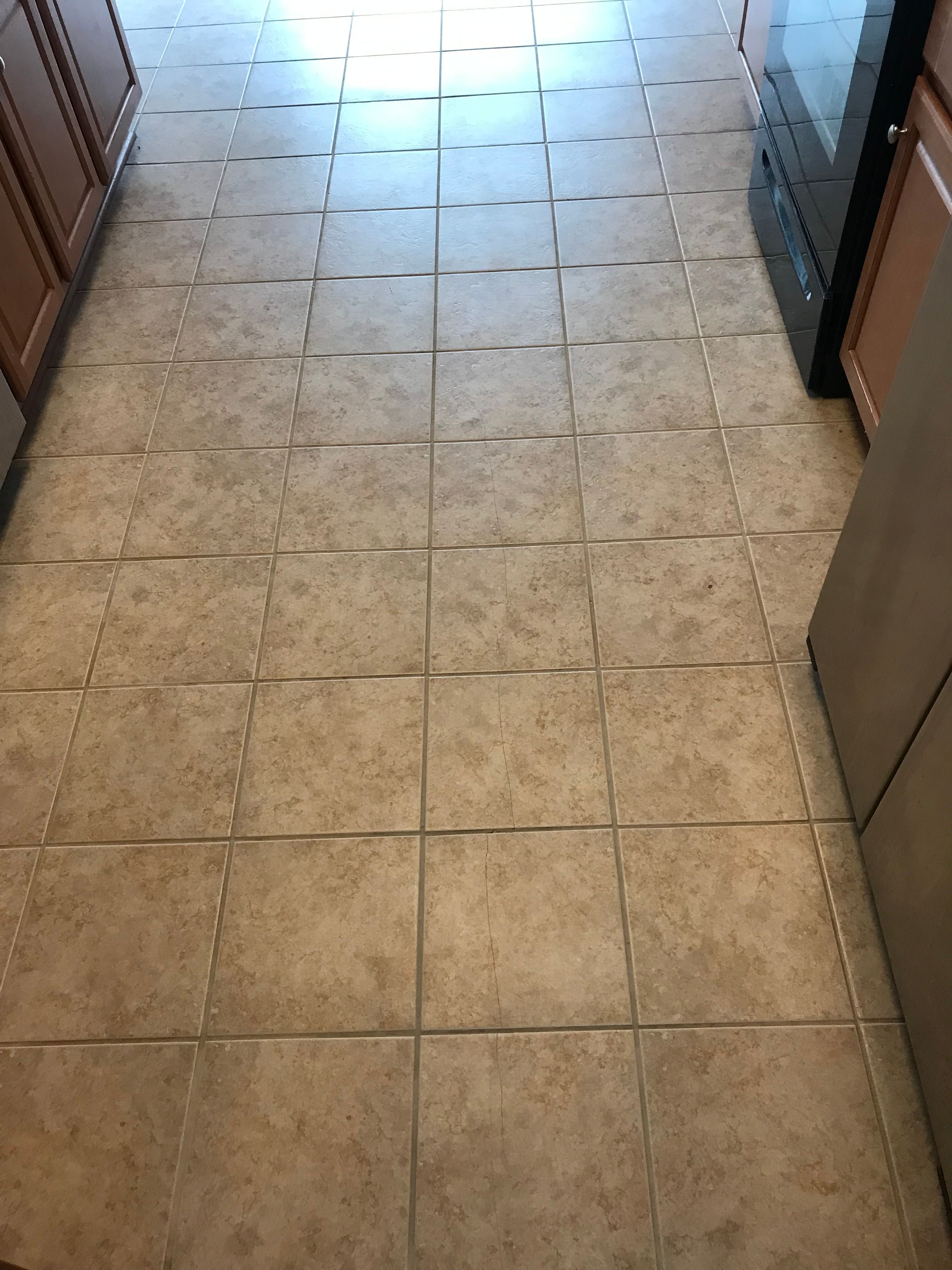 Clean kitchen tile floor with bright, even grout lines after professional cleaning